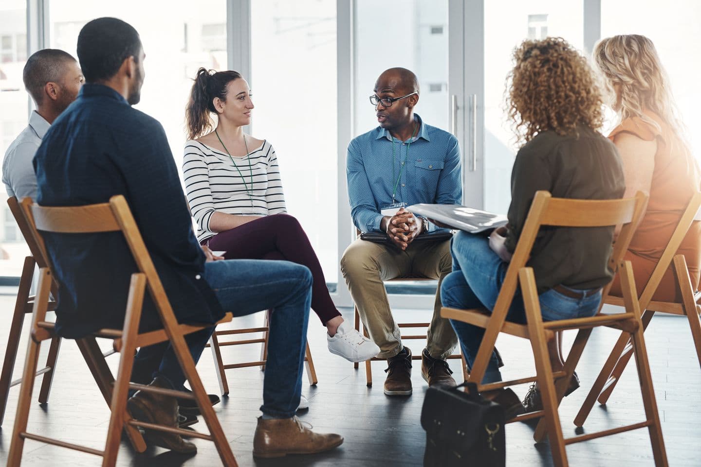 Group therapy participants sitting in circle